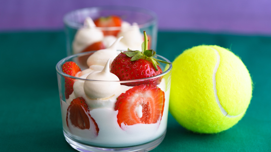 glass pot of strawberries and cream with Wimbledon tennis ball